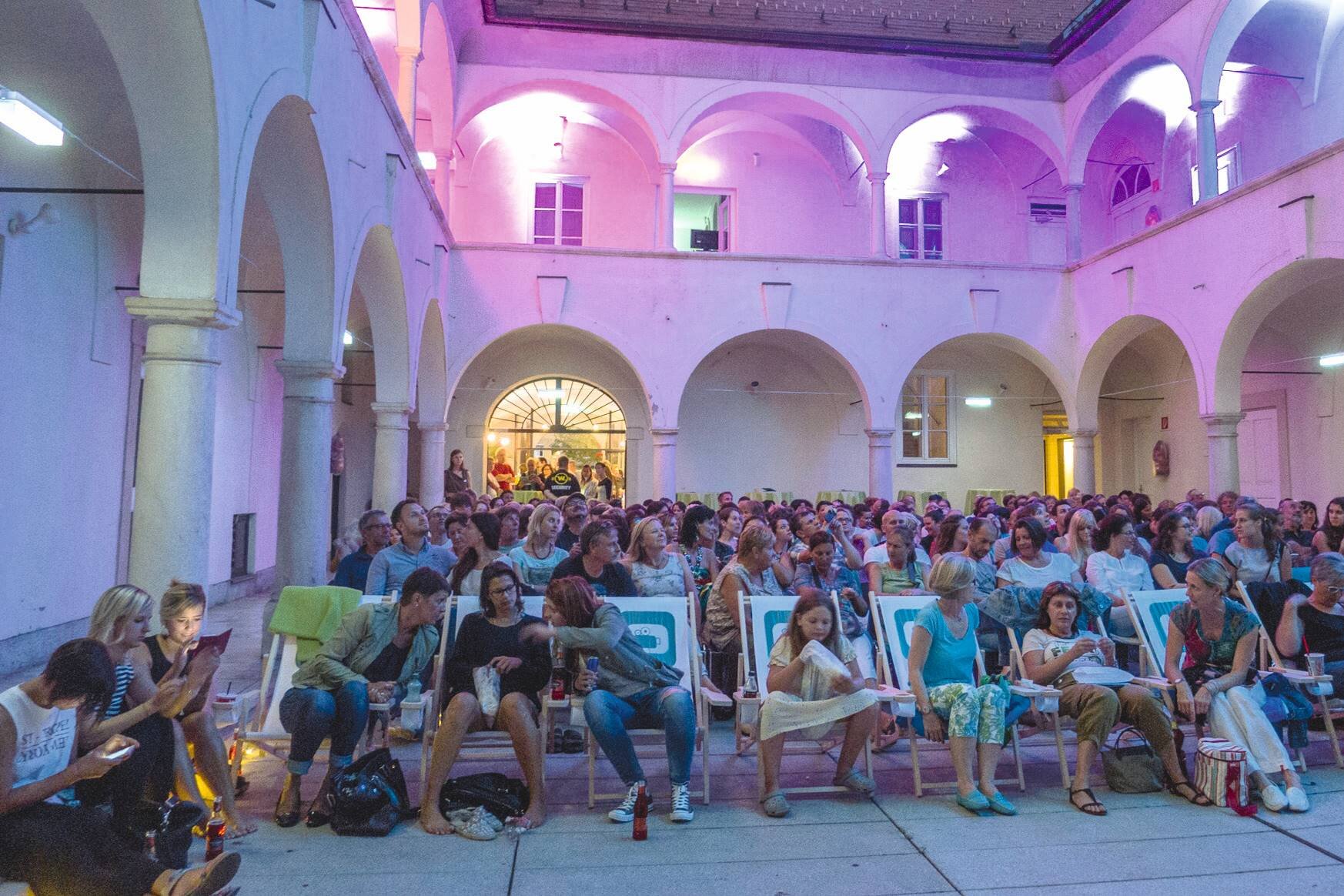 Visitors in the inner yard of the open air cinema in Villach